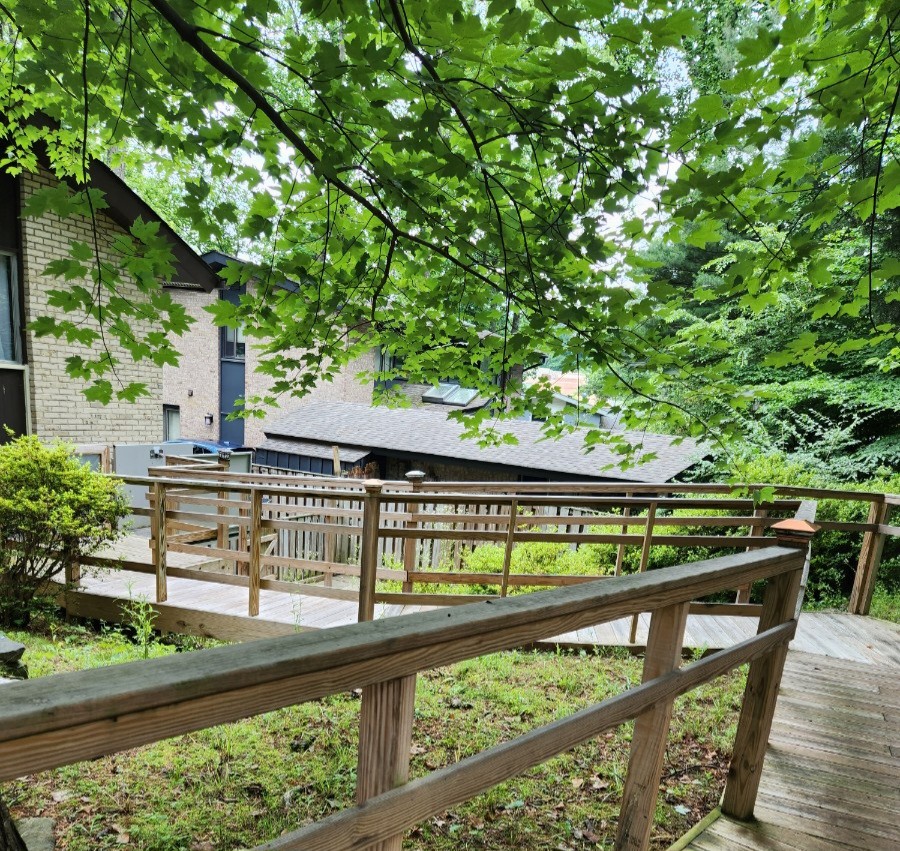 Wooden accessible ramp and deck through the garden