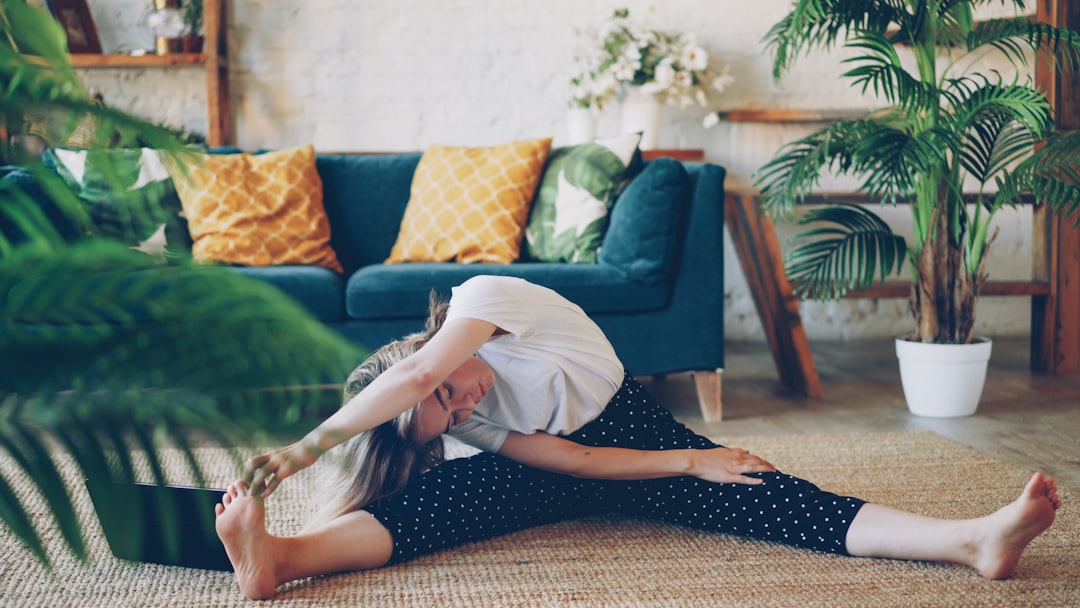 A senior doing a light stretching routine at home