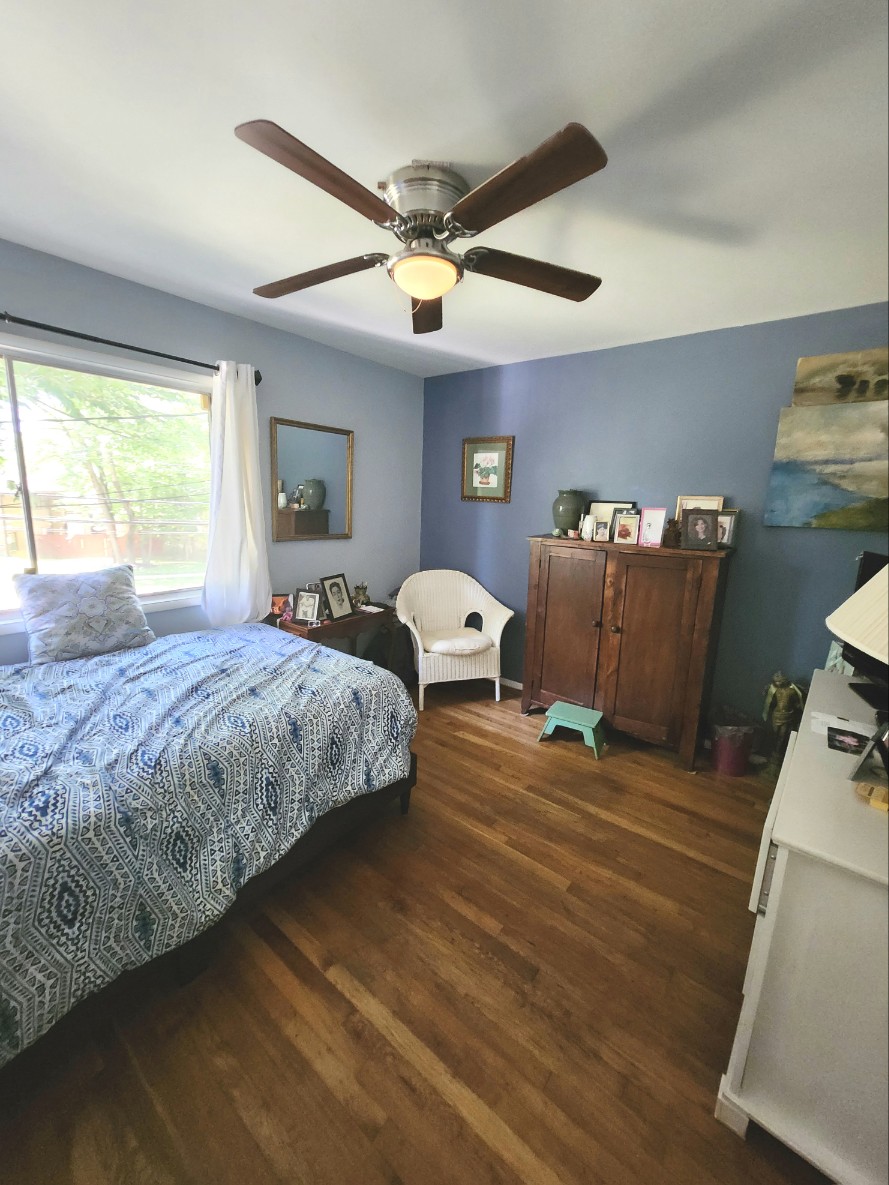 Private Room 2 with garden view, ceiling fan, and hardwood floors