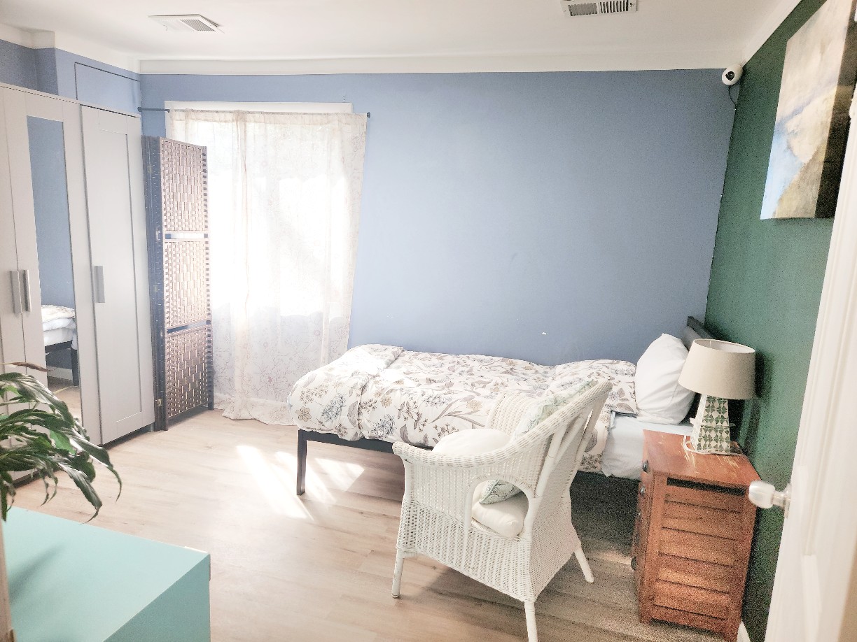 Private Room 3 in soft blue and sage tones with a privacy screen